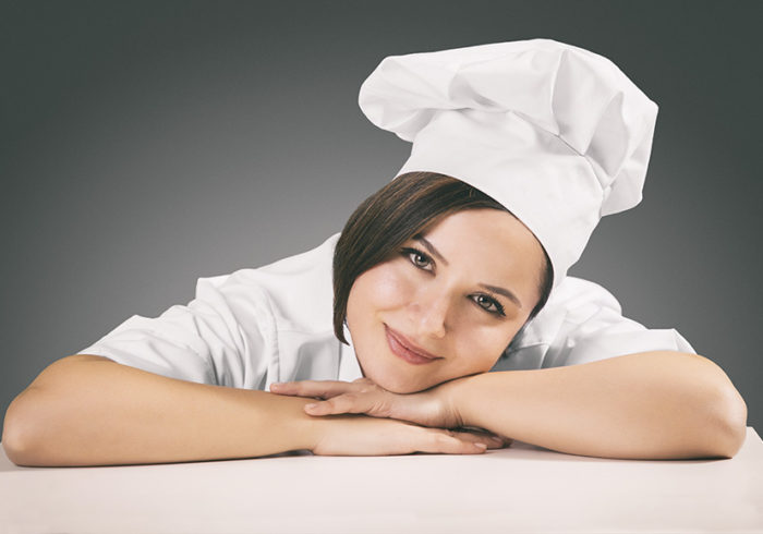 Lady chef smiling on the table